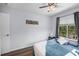 Comfortable bedroom featuring a ceiling fan and hardwood flooring at 1601 Fluorshire Dr, Brandon, FL 33511