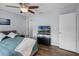 Comfortable bedroom features wood floors, neutral paint, and large window with backyard view at 1601 Fluorshire Dr, Brandon, FL 33511