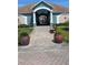 Inviting clubhouse entrance with potted plants and seating, offering a welcoming ambiance for residents at 1601 Fluorshire Dr, Brandon, FL 33511