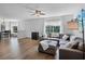 Bright living room features wood floors, neutral paint, and comfortable gray sectional sofa at 1601 Fluorshire Dr, Brandon, FL 33511