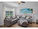 Cozy living room featuring a comfortable sofa, lots of pillows, and a serene beach-themed artwork at 1601 Fluorshire Dr, Brandon, FL 33511
