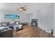 Comfortable living room features wood floors, neutral paint, and comfortable gray sectional sofa at 1601 Fluorshire Dr, Brandon, FL 33511