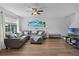 This living room features neutral paint, wood floors, comfortable gray sofa, and beachy decor at 1601 Fluorshire Dr, Brandon, FL 33511