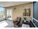 Charming screened-in porch with a cozy chair and an open sliding door leading to the home's interior at 1601 Fluorshire Dr, Brandon, FL 33511