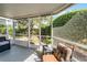Cozy screened-in porch featuring comfortable seating and providing a tranquil outdoor experience with beautiful backyard views at 1601 Fluorshire Dr, Brandon, FL 33511