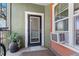 Outdoor balcony featuring a potted plant, small window unit, and brick facade at 1810 E Palm Ave # 5114, Tampa, FL 33605