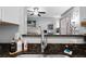 Kitchen sink featuring modern faucet and granite countertops with bar viewing living room at 1810 E Palm Ave # 5114, Tampa, FL 33605