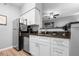 Modern kitchen with stainless steel appliances, white cabinets, and a breakfast bar for casual dining at 1810 E Palm Ave # 5114, Tampa, FL 33605