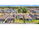 Aerial view of the property with a well-maintained backyard, water views, and solar panels on nearby houses at 1949 Parterre Ave, Lutz, FL 33558