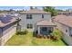 Aerial view of the backyard featuring a manicured lawn, lush landscaping, and privacy fence at 1949 Parterre Ave, Lutz, FL 33558