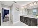 Modern bathroom with double sinks, granite countertops, dark wood cabinetry, and decorative floral elements at 1949 Parterre Ave, Lutz, FL 33558