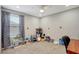 Playful bedroom featuring toys, a ceiling fan, and neutral-colored walls and carpeting at 1949 Parterre Ave, Lutz, FL 33558