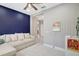 Cozy bonus room with a comfortable sofa, tile flooring, and soft lighting at 1949 Parterre Ave, Lutz, FL 33558