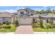Charming two-story home with a well-manicured lawn and a brick-paved driveway at 1949 Parterre Ave, Lutz, FL 33558