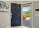 View through an open front door revealing the home's entrance and a glimpse of the exterior at 1949 Parterre Ave, Lutz, FL 33558