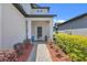 Inviting front entrance featuring a covered porch, well-maintained landscaping, and a paved walkway at 1949 Parterre Ave, Lutz, FL 33558