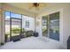 Screened patio with ceiling fan, view of the backyard and sliding glass door at 1949 Parterre Ave, Lutz, FL 33558