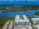 Stunning aerial view of a waterfront condo complex with pool, parking, and docks on the bay at 19531 Gulf Blvd # 604, Indian Shores, FL 33785