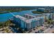 Serene waterfront condo complex with lush landscaping, a parking lot, and picturesque water views at 19531 Gulf Blvd # 604, Indian Shores, FL 33785