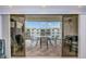 Inviting outdoor balcony with a table and chairs providing a great space for relaxation and dining at 19531 Gulf Blvd # 604, Indian Shores, FL 33785