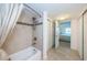 Combination bathtub shower with tile surround and access to the bedroom in the background at 19531 Gulf Blvd # 604, Indian Shores, FL 33785