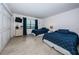 Bright bedroom featuring two beds, neutral tile and a window with water view at 19531 Gulf Blvd # 604, Indian Shores, FL 33785