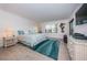 Bright bedroom with coastal decor, tiled floors, and slider to the balcony at 19531 Gulf Blvd # 604, Indian Shores, FL 33785