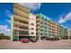 Exterior view of a residential complex showing the covered parking area and several balconies at 19531 Gulf Blvd # 604, Indian Shores, FL 33785