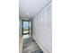 Bright hallway featuring tile floors, closet, and a doorway leading to an outdoor balcony at 19531 Gulf Blvd # 604, Indian Shores, FL 33785