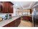 Kitchen area with stainless steel appliances, granite counters, and view to dining area at 19531 Gulf Blvd # 604, Indian Shores, FL 33785