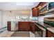 Open-concept kitchen has stainless steel appliances, tile backsplash, and granite countertops at 19531 Gulf Blvd # 604, Indian Shores, FL 33785