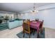 Living room and dining room area with comfortable seating and a balcony at 19531 Gulf Blvd # 604, Indian Shores, FL 33785