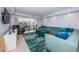 Comfortable living room with plush sectional sofa and slider doors to balcony with outdoor furniture at 19531 Gulf Blvd # 604, Indian Shores, FL 33785