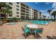 Enjoy the community pool and spa surrounded by plenty of chairs and a well-maintained brick deck at 19531 Gulf Blvd # 604, Indian Shores, FL 33785