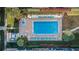 Aerial shot of a large in-ground pool with lounge chairs and lush landscaping at 19531 Gulf Blvd # 604, Indian Shores, FL 33785