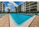 Inviting community pool with lounge chairs and a meticulously maintained deck, perfect for relaxation at 19531 Gulf Blvd # 604, Indian Shores, FL 33785