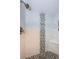 Glass shower with white tile surround and decorative vertical tile accents at 19531 Gulf Blvd # 604, Indian Shores, FL 33785