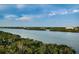 Breathtaking view of the serene water from this property, surrounded by lush trees and greenery at 19531 Gulf Blvd # 604, Indian Shores, FL 33785