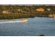 Gorgeous view of waterway, with powerboat cruising along the coast, and homes nestled in the woods at 19531 Gulf Blvd # 604, Indian Shores, FL 33785
