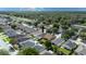 An aerial view of a single-Gathering home in a residential neighborhood with a screened-in pool and fenced backyard at 24405 Summer Wind Ct, Lutz, FL 33559