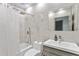 Beautiful marble bathroom with rain shower head, modern vanity, and large mirror at 24405 Summer Wind Ct, Lutz, FL 33559