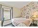 Bedroom with floral wallpaper, window view, and modern decor at 24405 Summer Wind Ct, Lutz, FL 33559
