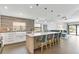 Open-concept kitchen with island seating, stylish pendant lighting, and adjacent living area at 24405 Summer Wind Ct, Lutz, FL 33559
