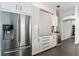 Kitchen featuring stainless steel refrigerator, wine cooler, and modern cabinets at 24405 Summer Wind Ct, Lutz, FL 33559