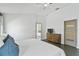 Spacious main bedroom with modern dresser, ceiling fan, and en-suite bathroom access at 24405 Summer Wind Ct, Lutz, FL 33559