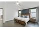 Comfortable main bedroom with natural light, blue accent wall, and tiled floors at 24405 Summer Wind Ct, Lutz, FL 33559