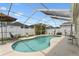 Enclosed pool area featuring a pool, ample deck space, and an umbrella for shade at 24405 Summer Wind Ct, Lutz, FL 33559
