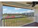 Balcony that overlooks a tennis court, a grassy area and some nearby buildings at 269 Madeira Cir, Tierra Verde, FL 33715