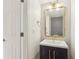 Charming half bathroom with stylish vanity, framed mirror, and decorative backsplash at 269 Madeira Cir, Tierra Verde, FL 33715