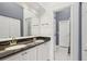 Bathroom featuring dual sinks, granite countertops and a well-lit vanity area at 269 Madeira Cir, Tierra Verde, FL 33715